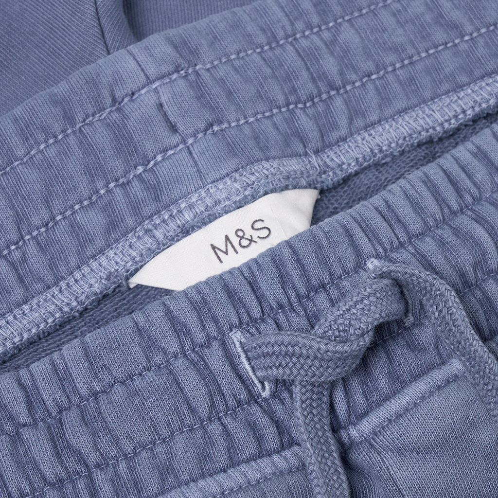 Close-up of blue textured fabric with a M&S label
