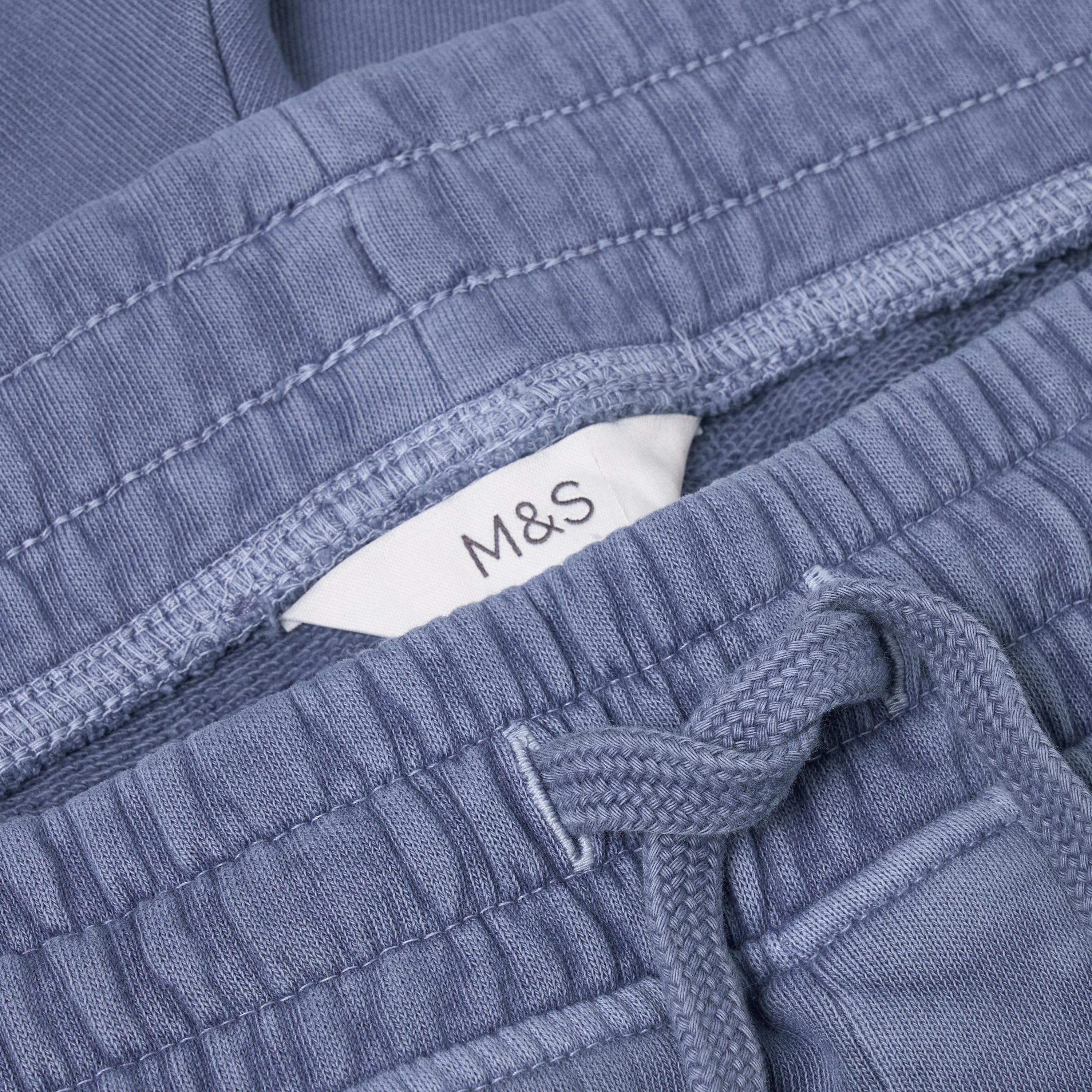 Close-up of blue textured fabric with a M&S label