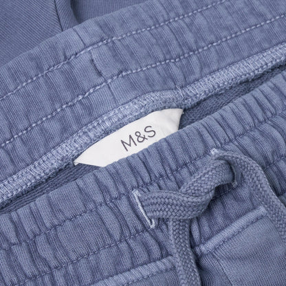 Close-up of blue textured fabric with a M&S label