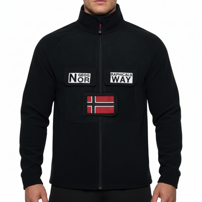 A black zip-up fleece jacket with a stand-up collar, featuring two front pockets with white patches reading 'GEOG NOR' and 'RAPHICALS WAY', plus a red and white Norwegian flag patch on the lower chest. The jacket is shown on a plain white background.