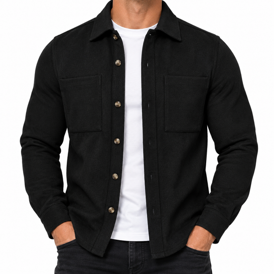 A man wearing a black long-sleeve button-up overshirt jacket over a white t-shirt and dark jeans, shown from the neck down against a plain white background.