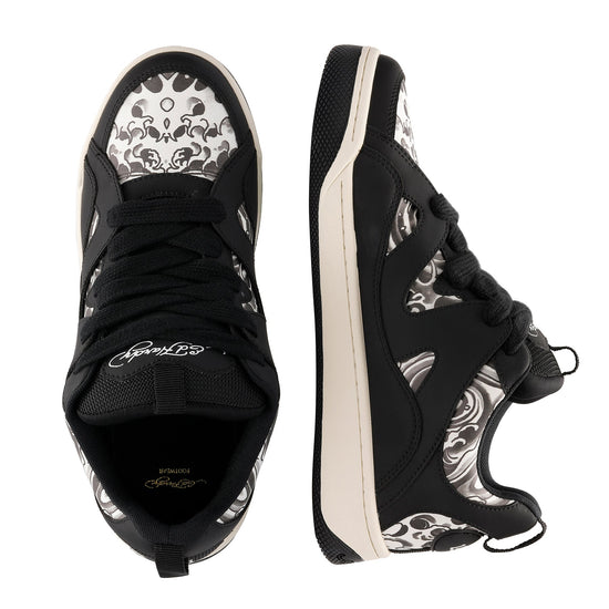 Black sneakers with white floral patterns on a white background