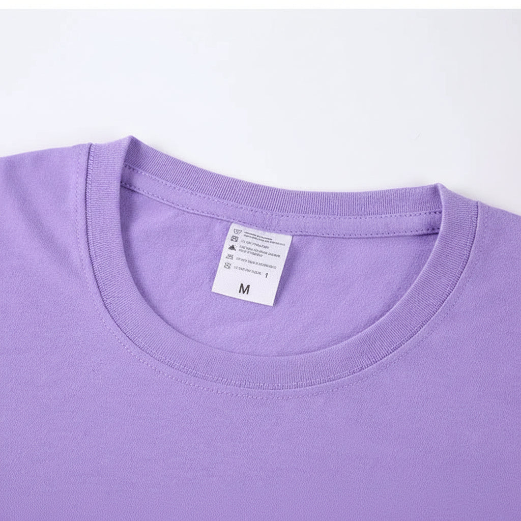 Close-up of a purple t-shirt with a label on a white background