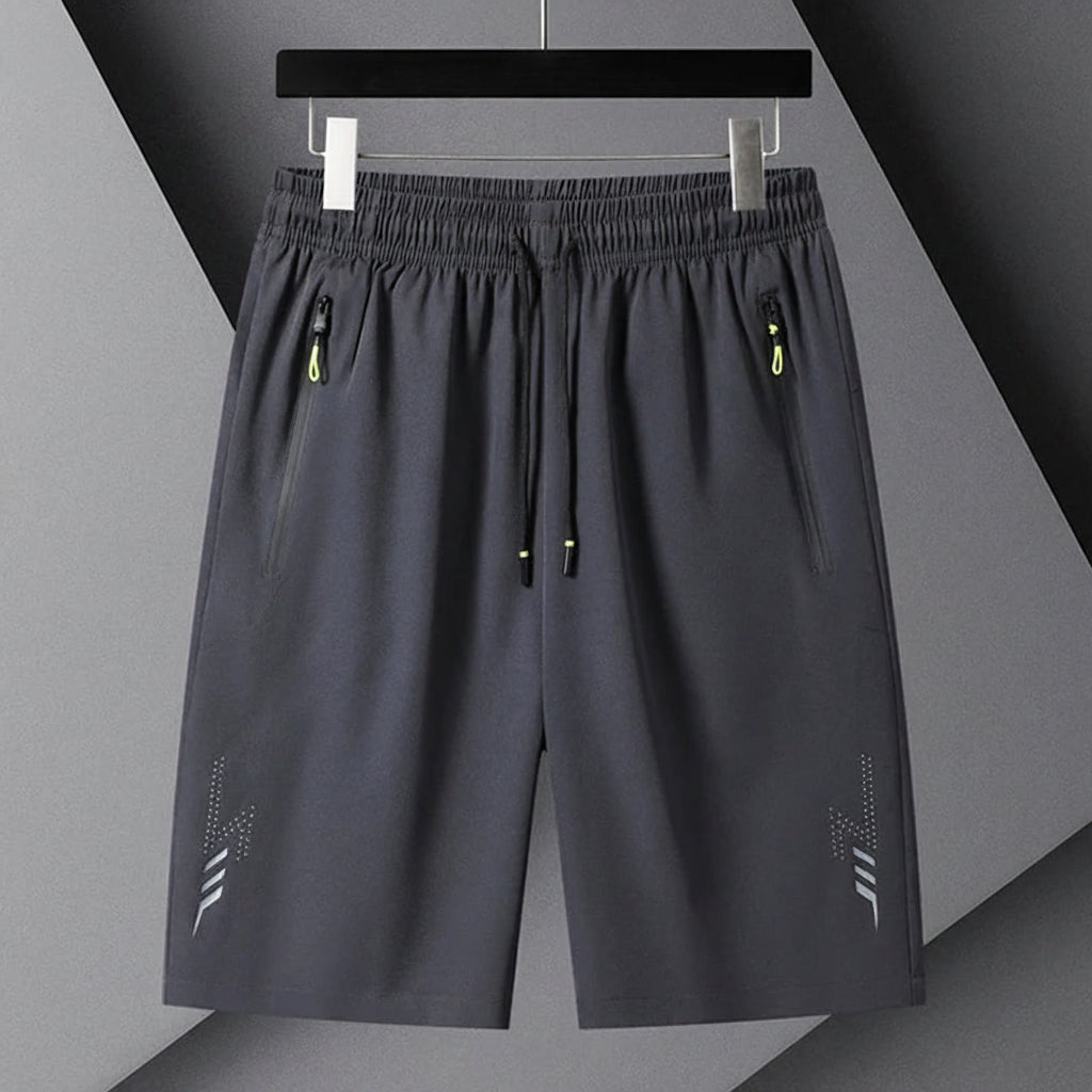 Gray shorts with black drawstring on a gray background