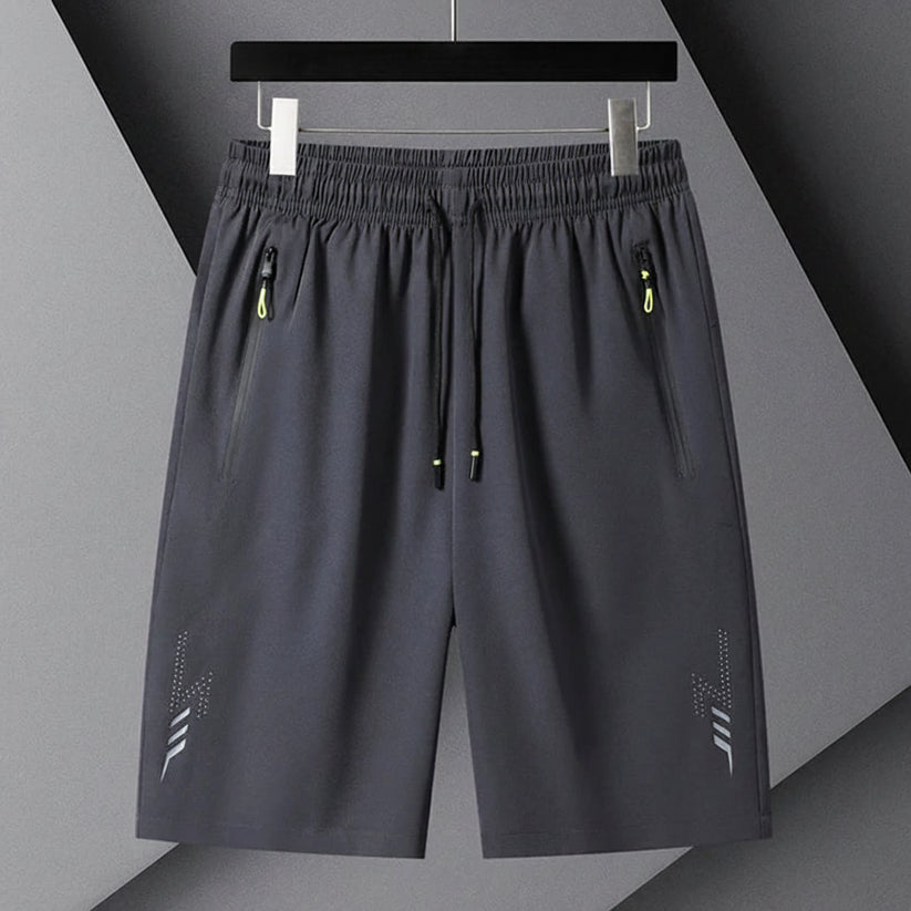 Gray shorts with black drawstring on a gray background