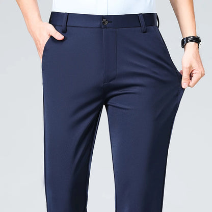 Navy blue pants worn by a person on a light gray background