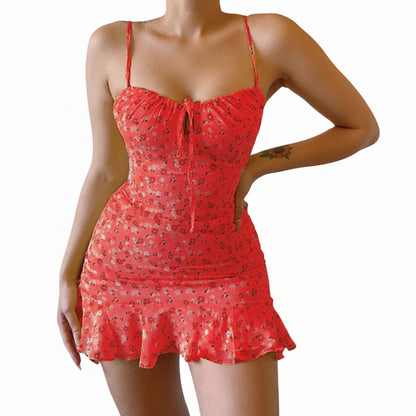 Red patterned dress worn by a person against a plain background