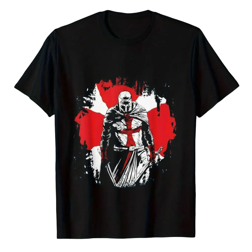 A black short-sleeve t-shirt with a graphic print of a knight in armor holding a sword, set against a red and white splattered background. The text 'Deus Vult' is printed in a white gothic font above the graphic.