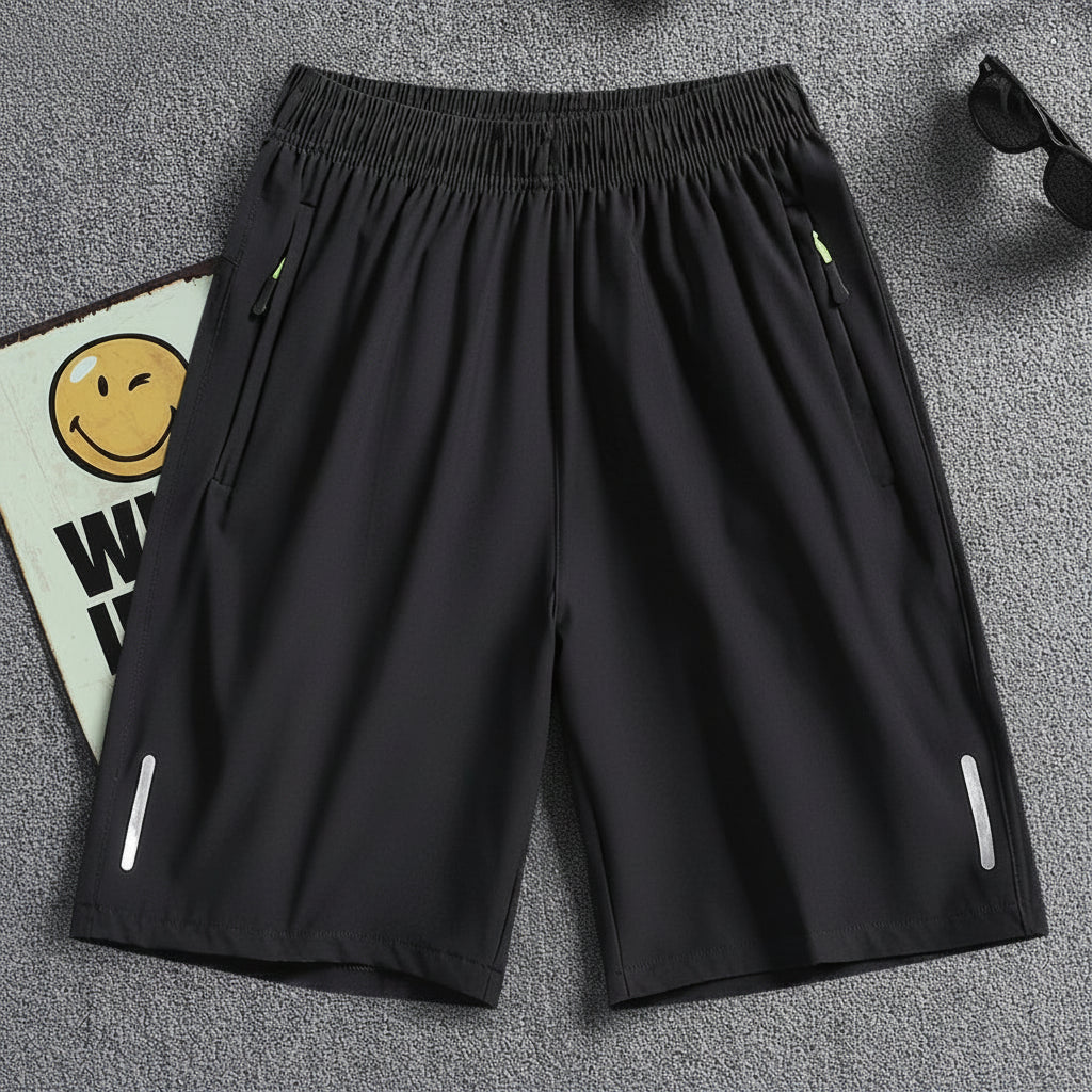 Black shorts on a gray background with 'MANTLCONX' branding.