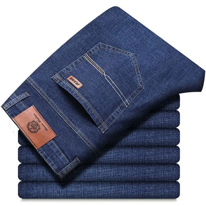 Stack of blue jeans with a brand label on a white background
