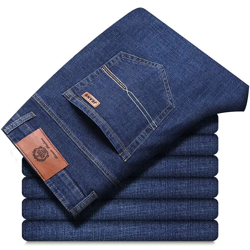 Stack of blue jeans with a brand label on a white background