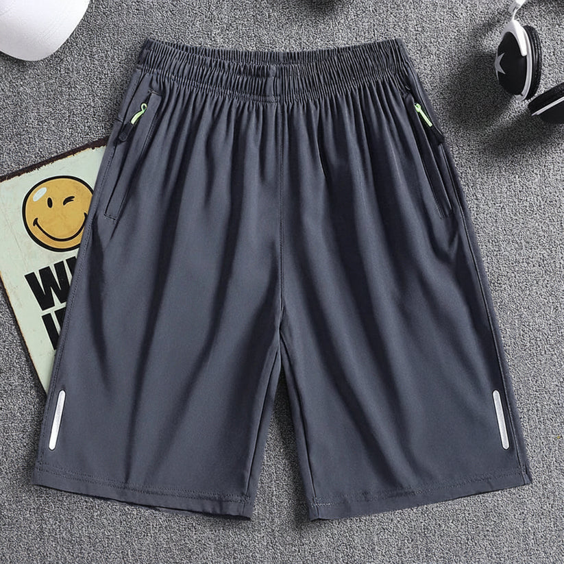 Gray shorts with zippers on a gray background, featuring the brand 'MANTLCONX'.