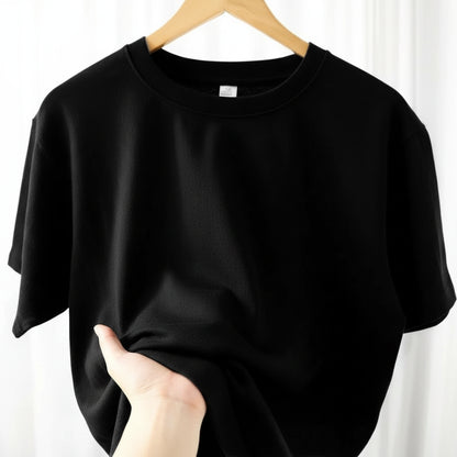 Black t-shirt on a hanger against a white background