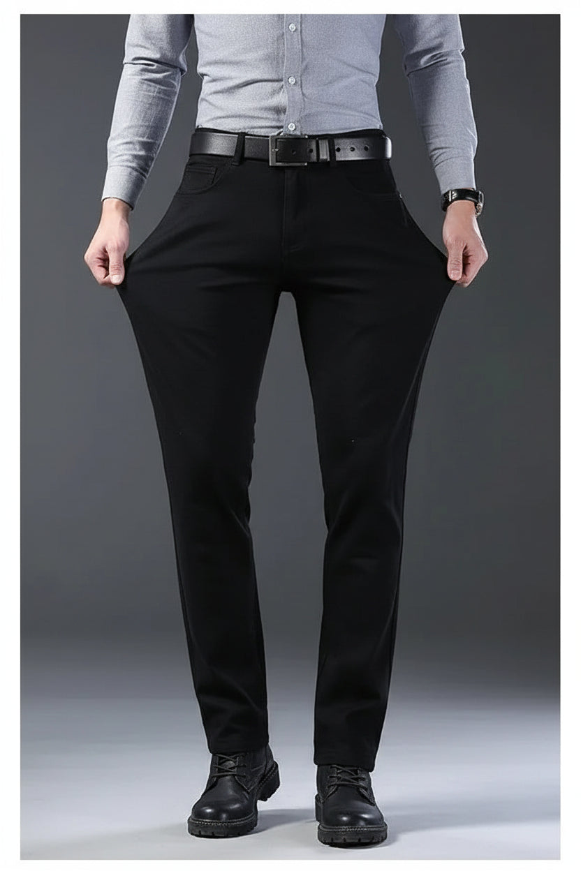 Person wearing black pants on a gray background