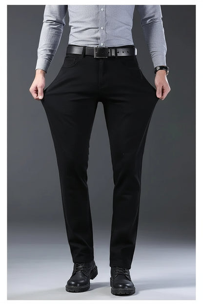 Person wearing black pants on a gray background