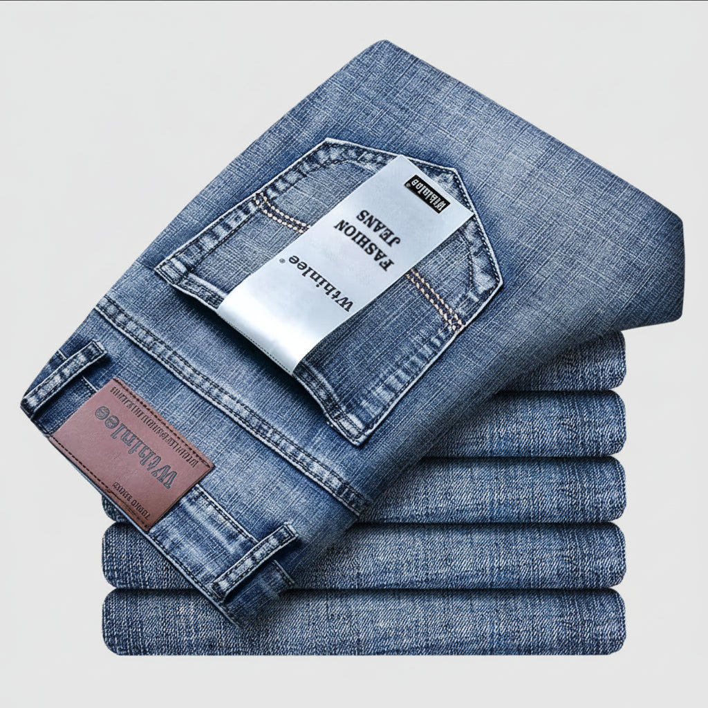 Stack of folded blue jeans with visible brand labels on a light gray background