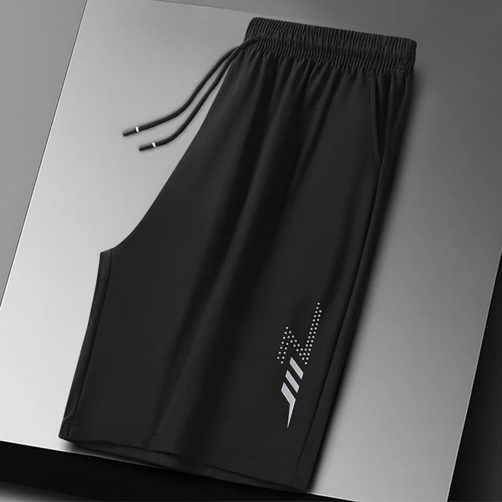 Black shorts with a brand logo on a gray background
