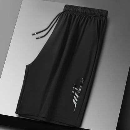 Black shorts with a brand logo on a gray background