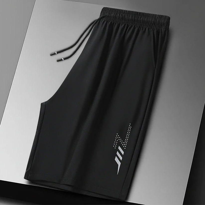 Black shorts with a brand logo on a gray background