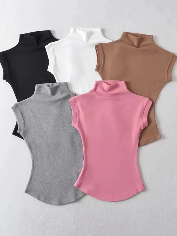 Five sleeveless shirts in black, white, brown, gray, and pink on a light gray background.