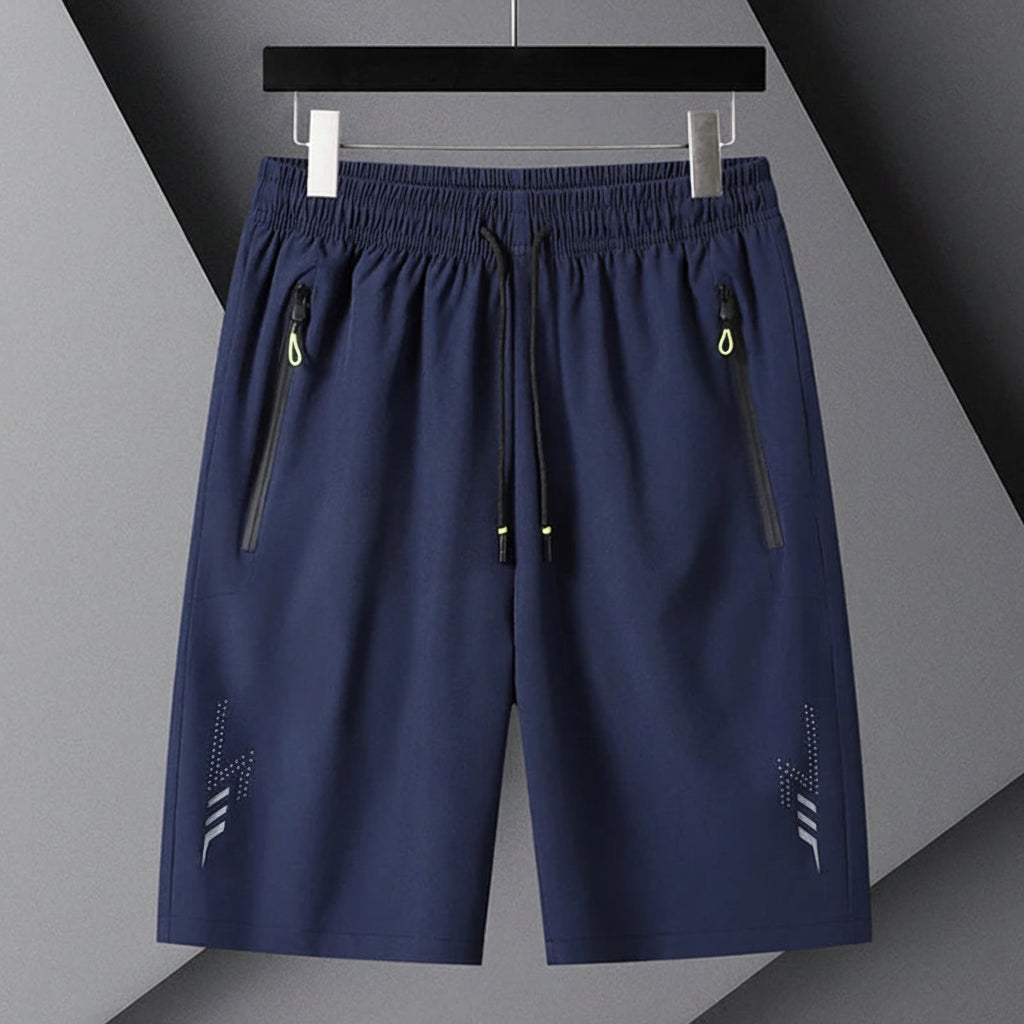 Navy blue shorts with zippers on a gray background