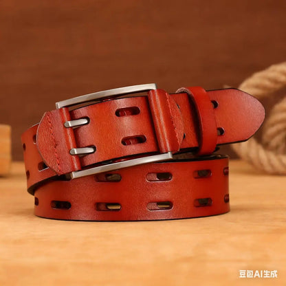 A reddish-brown leather belt with a silver metal buckle, coiled on a wooden surface with a warm brown background.