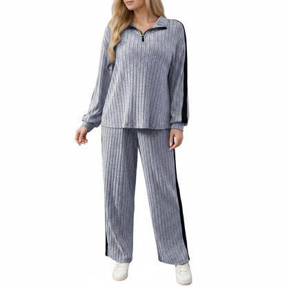 Woman in a ribbed knit outfit holding a coffee cup in a minimalistic room.