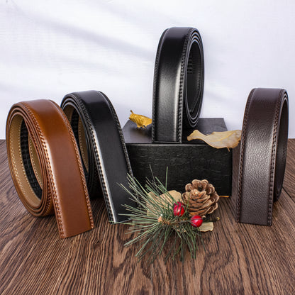 Four leather belts in different colors on a wooden surface with decorative elements.