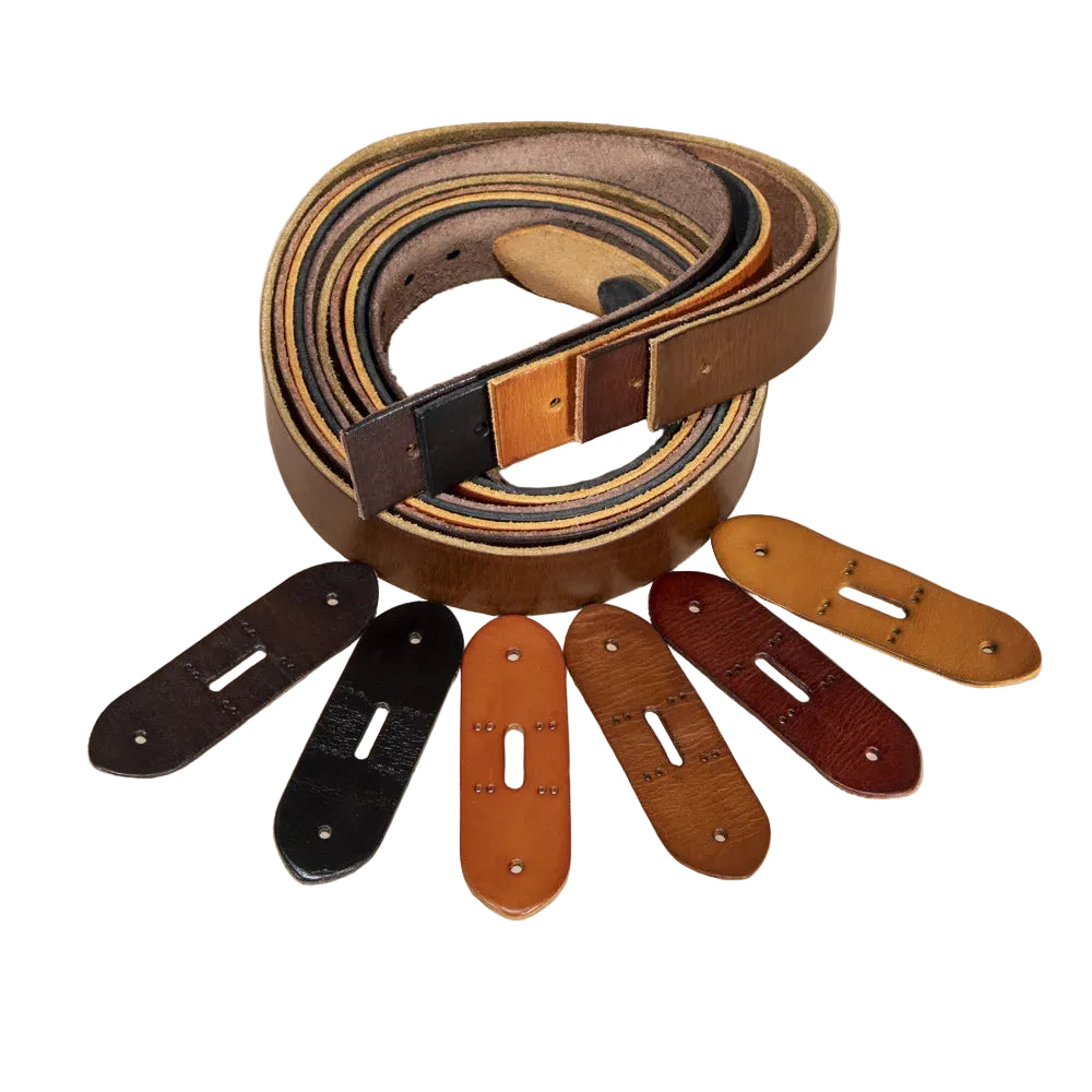 A coiled brown leather belt with a tan buckle, displayed on a warm beige background with five matching adjustable leather loops arranged in front.