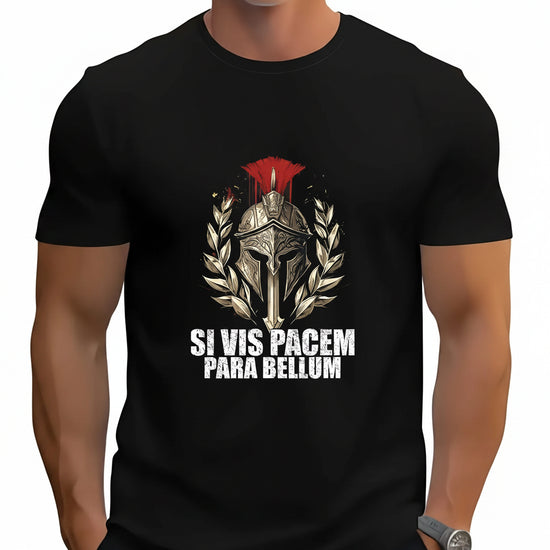 A man wearing a black short-sleeve t-shirt with a graphic of a Roman gladiator helmet, laurel wreath, and red plume, with the text 'SI VIS PACEM PARA BELLUM' printed below in white.