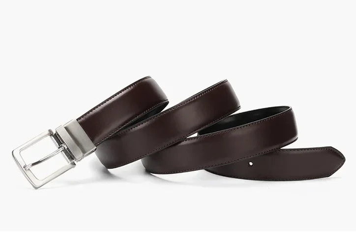 Brown leather belt with silver buckle on a white background
