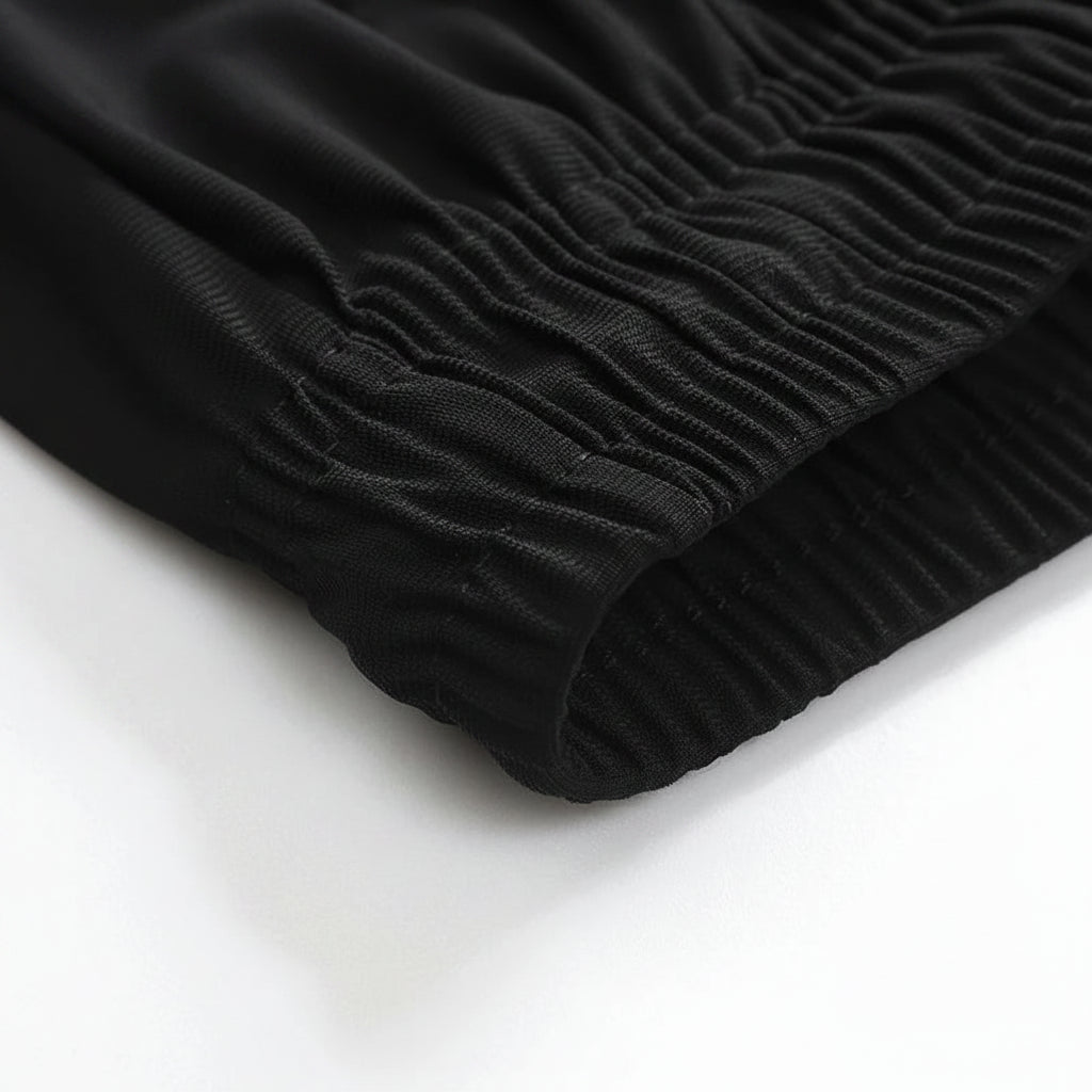 Close-up of black ribbed fabric on a white background