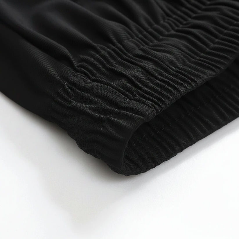 Close-up of black ribbed fabric on a white background