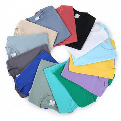 Stack of folded colorful t-shirts on a white background