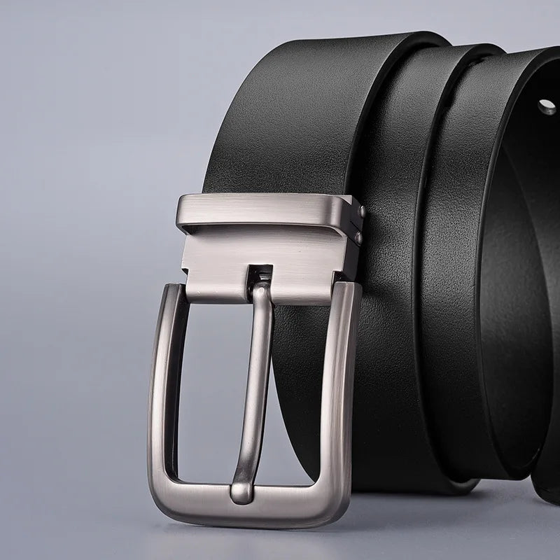 Black leather belt with a silver buckle on a light gray background