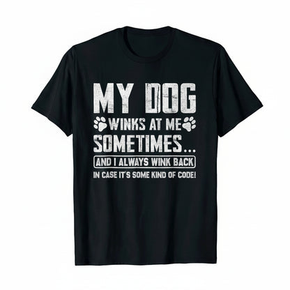 A black short-sleeve crewneck t-shirt with a humorous white graphic print on the front that reads 'MY DOG WINKS AT ME SOMETIMES.