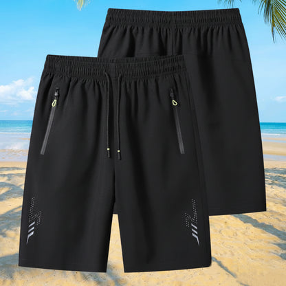 Black shorts with zippers on a beach background, featuring the brand 'MANTLCONX'.