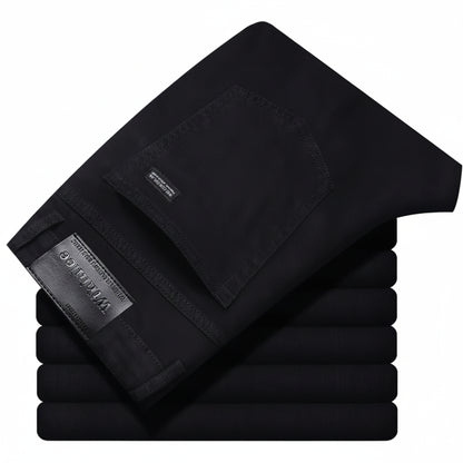 Stack of black pants with a brand label on a white background