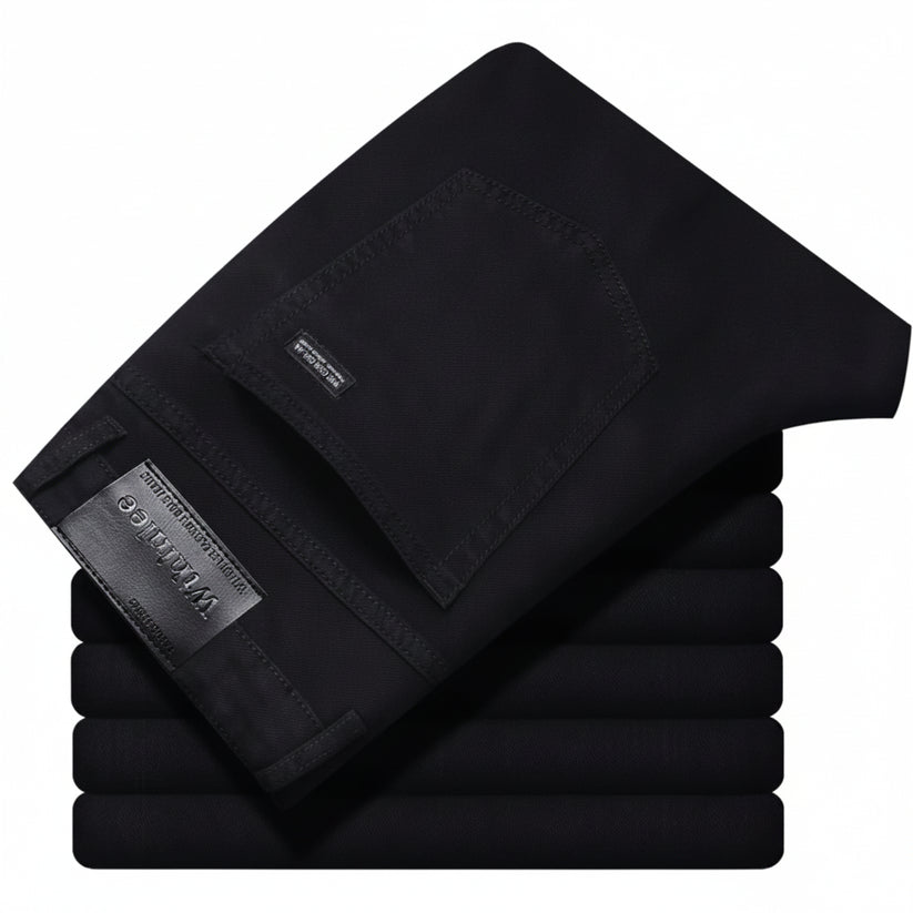 Stack of black pants with a brand label on a white background