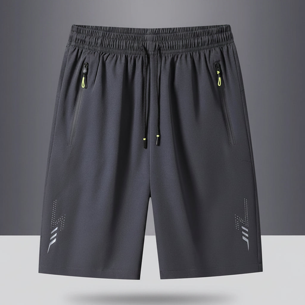 Gray shorts with drawstring and zippers on a gray background, featuring the brand 'MANTLCONX'.