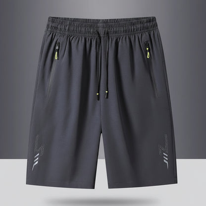 Gray shorts with drawstring and zippers on a gray background, featuring the brand 'MANTLCONX'.