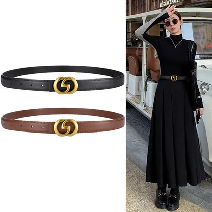 Black and brown belts with gold interlocking circle buckle next to a person wearing a black outfit with a matching belt.