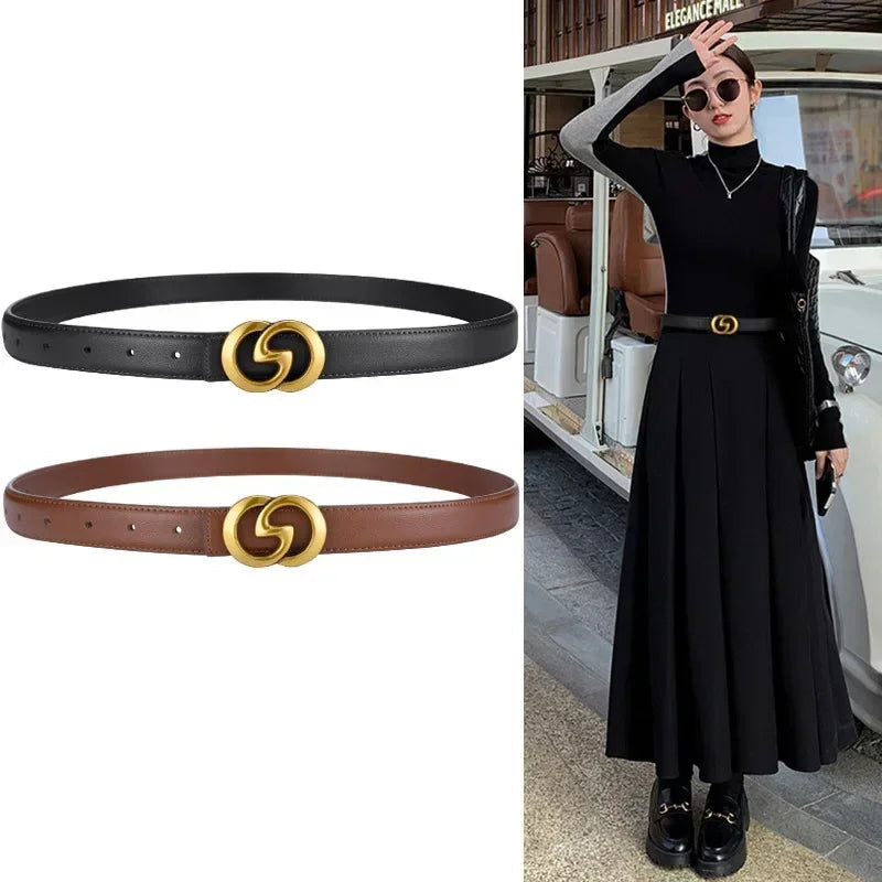 Black and brown belts with gold interlocking circle buckle next to a person wearing a black outfit with a matching belt.