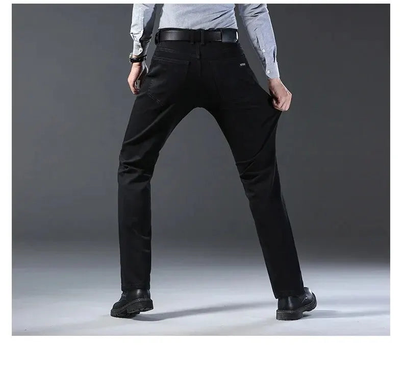 Person wearing black pants on a gray background