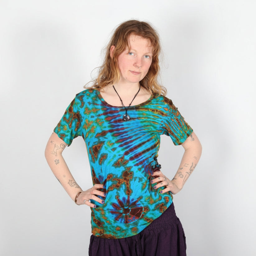 Person wearing a tie-dye shirt with a plain background