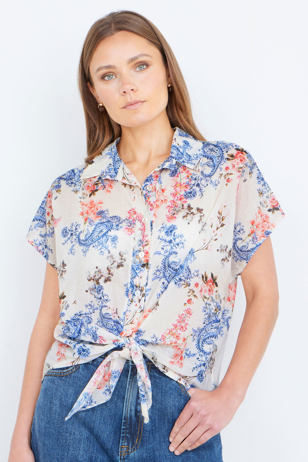 Woman wearing a floral blouse with a white background