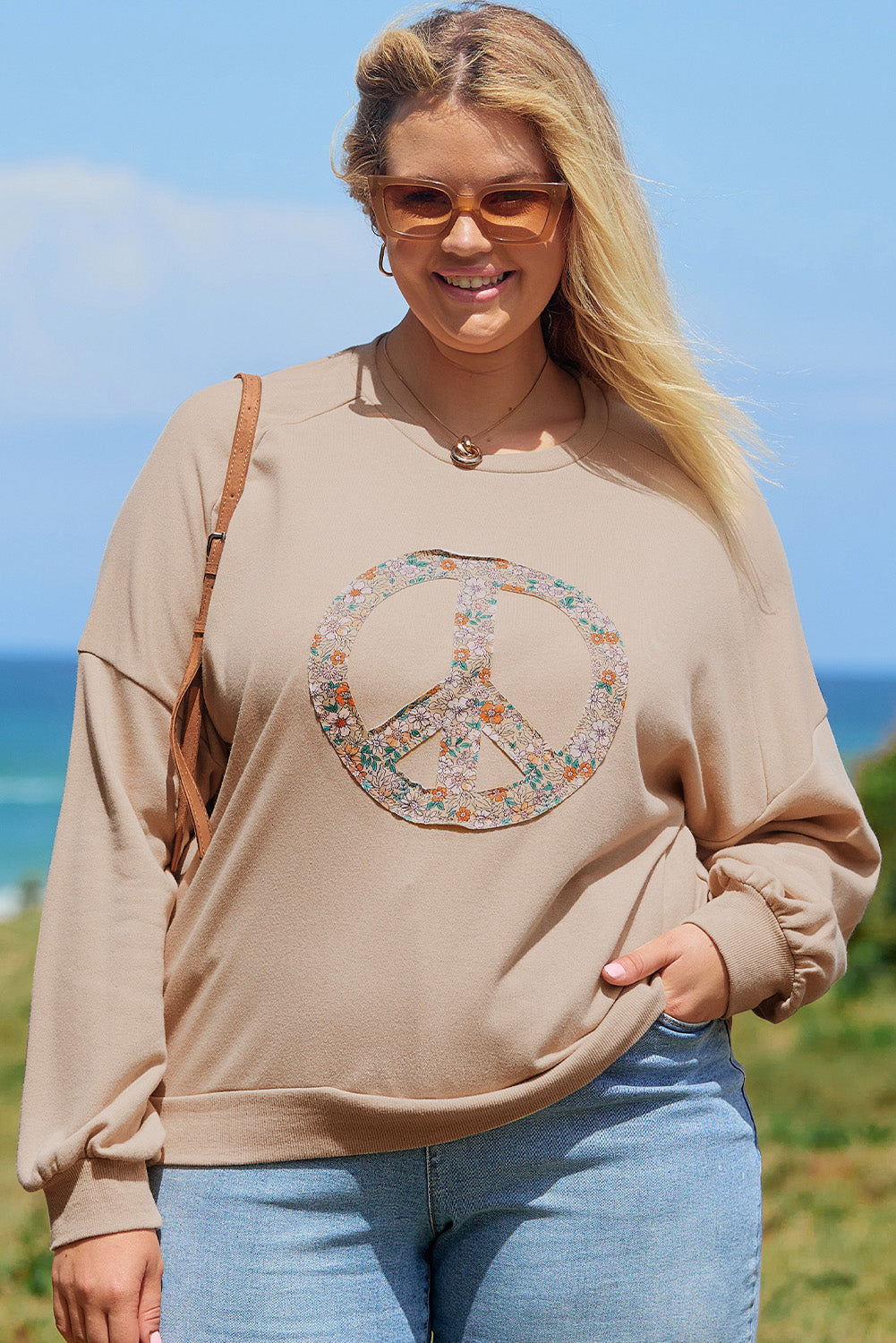 A pale khaki plus-size sweatshirt featuring a floral peace sign graphic and a Washed Terry Finish