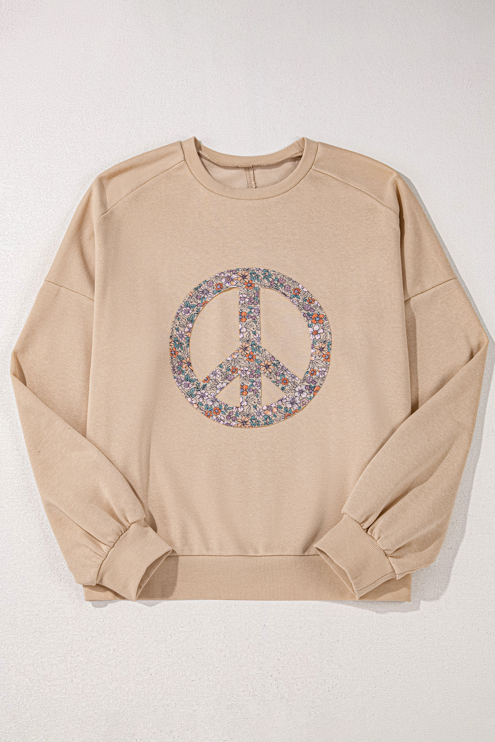 A pale khaki plus-size sweatshirt featuring a floral peace sign graphic and a Washed Terry Finish