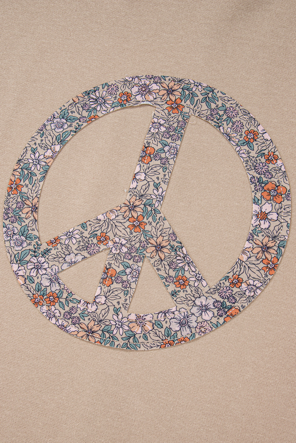 A pale khaki plus-size sweatshirt featuring a floral peace sign graphic and a Washed Terry Finish