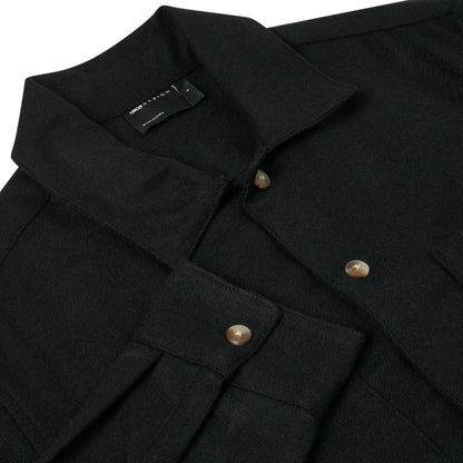 Close-up of a black wool-blend button-up shirt jacket by Uniqlo's UGC Collection, featuring a collar, buttoned chest pocket, and brown shell-like buttons on a white background.